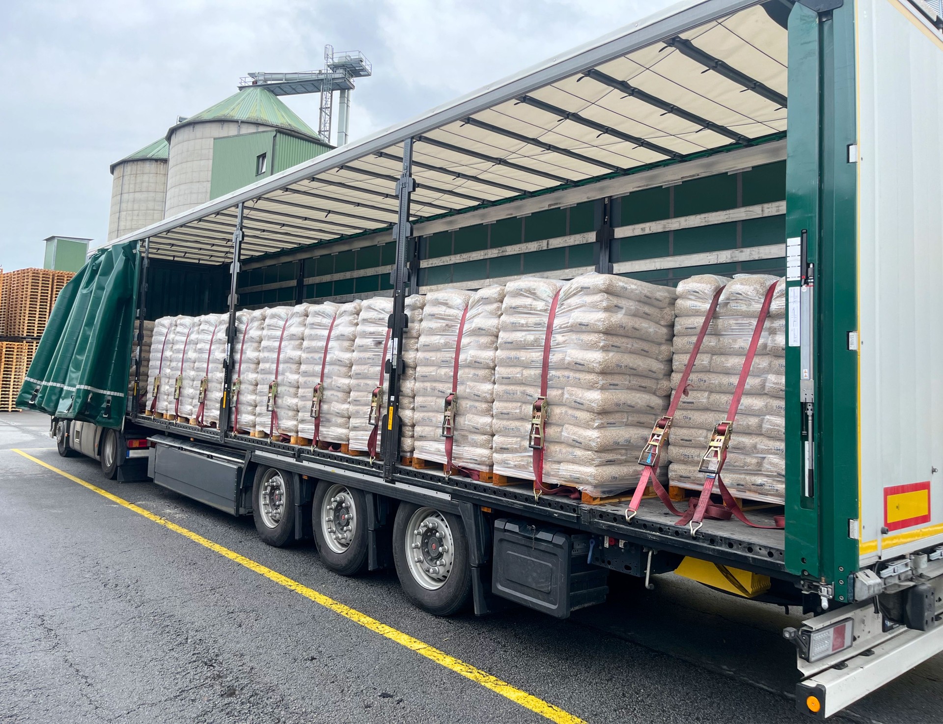 Packed wood pellets on pallets loaded into a semi-trailer for transportation