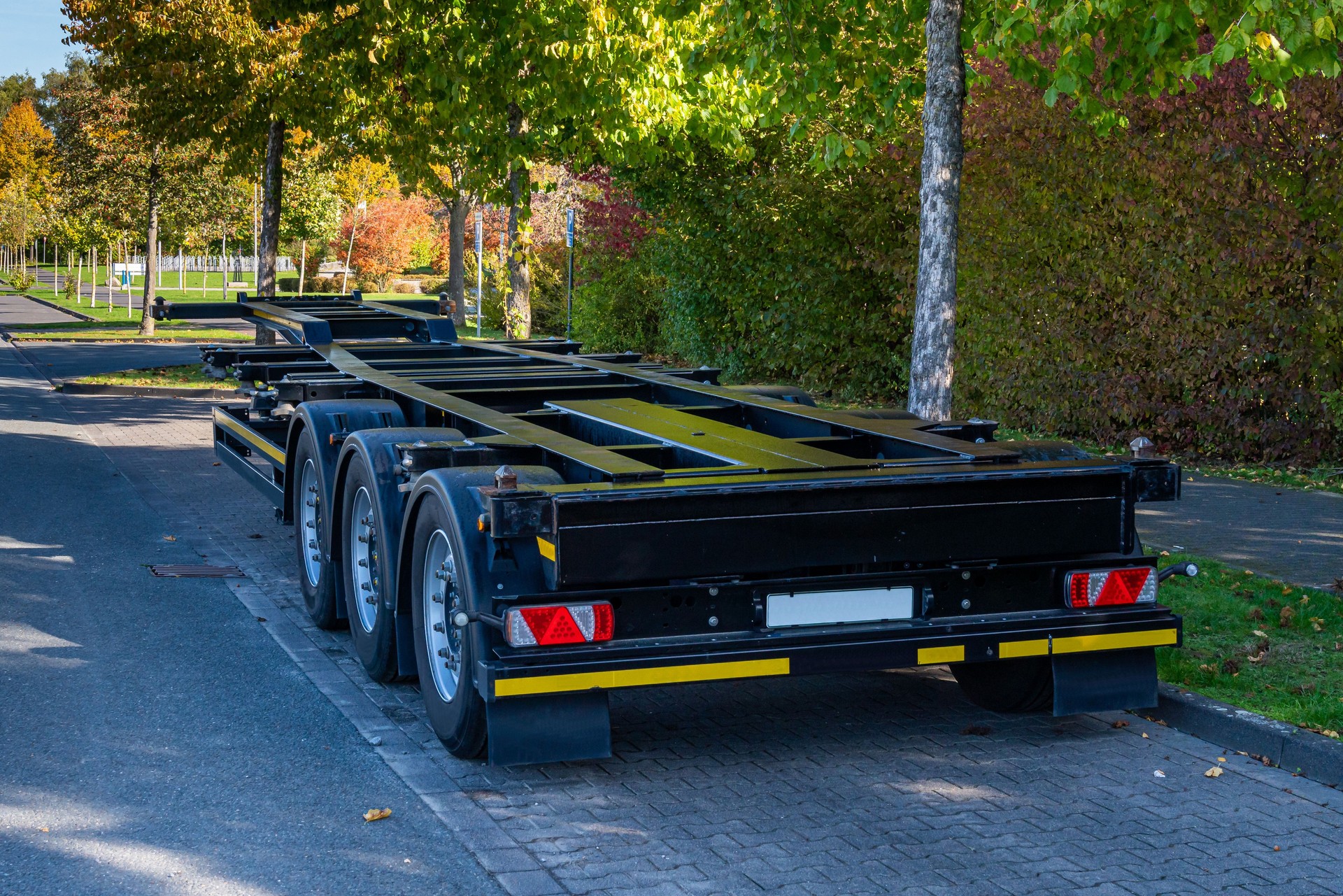 Standing on the side of the trailer platform truck.