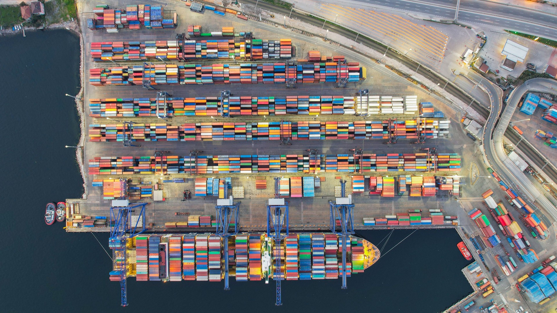 Containers lined up in the port, shot from above with a drone